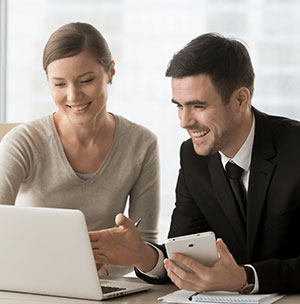 people-smiling-looking-at-laptop