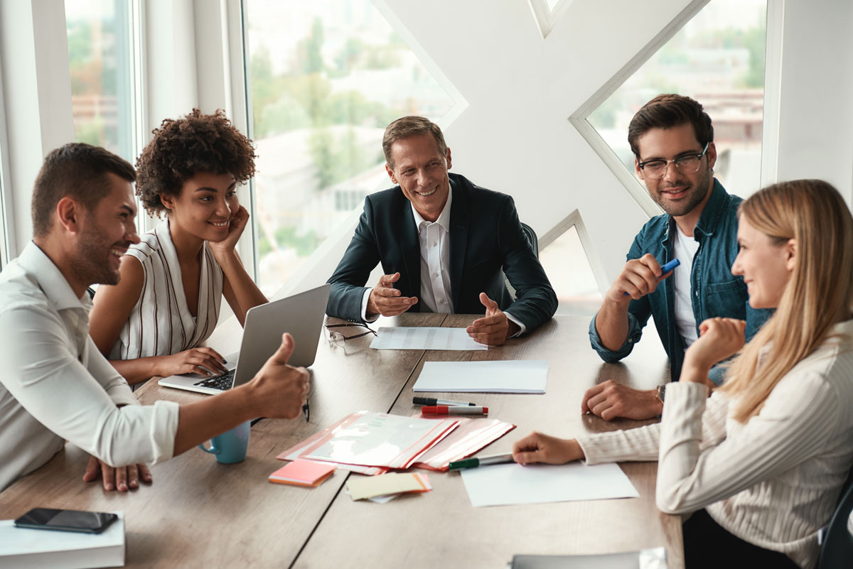 Group of business people collaborating together at a table.
